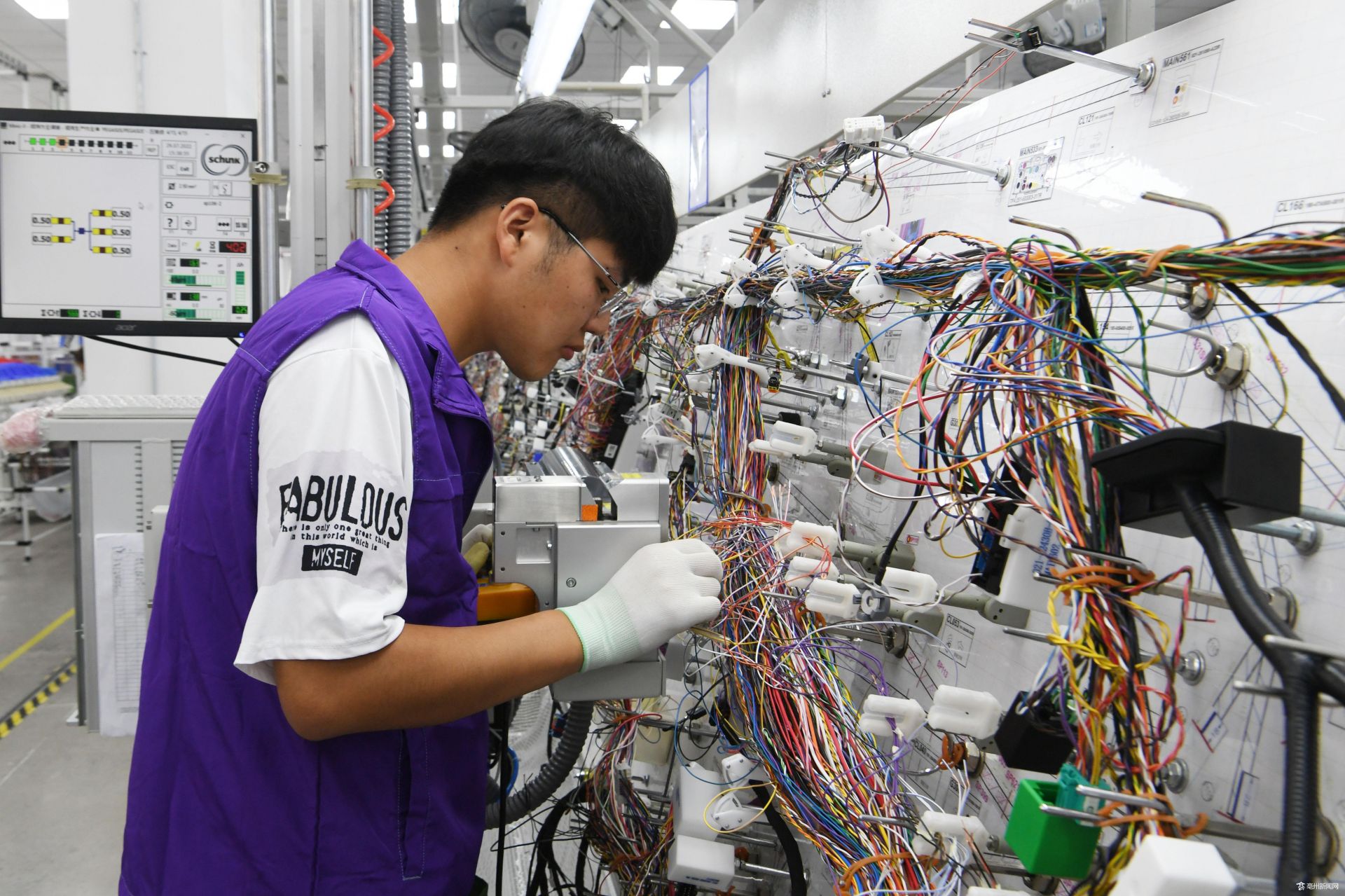 7月29日,谯城区经开区立讯精密汽车线束生产车间,工人正忙着生产新